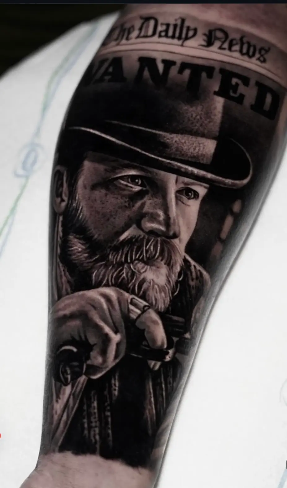 Realistic portrait tattoo of Alfie with detailed facial in black and grey.